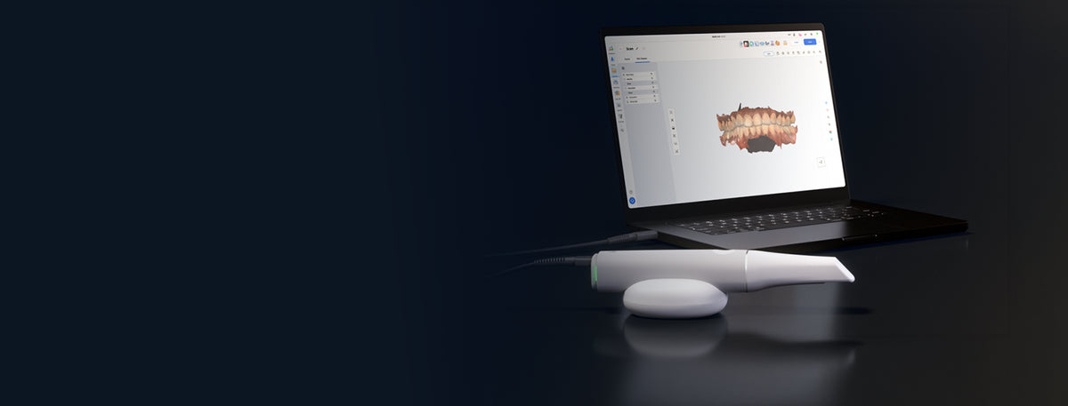 Medit iE on its cradle beside a laptop displaying a dental scan in Medit Link