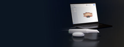 Medit iE on its cradle beside a laptop displaying a dental scan in Medit Link